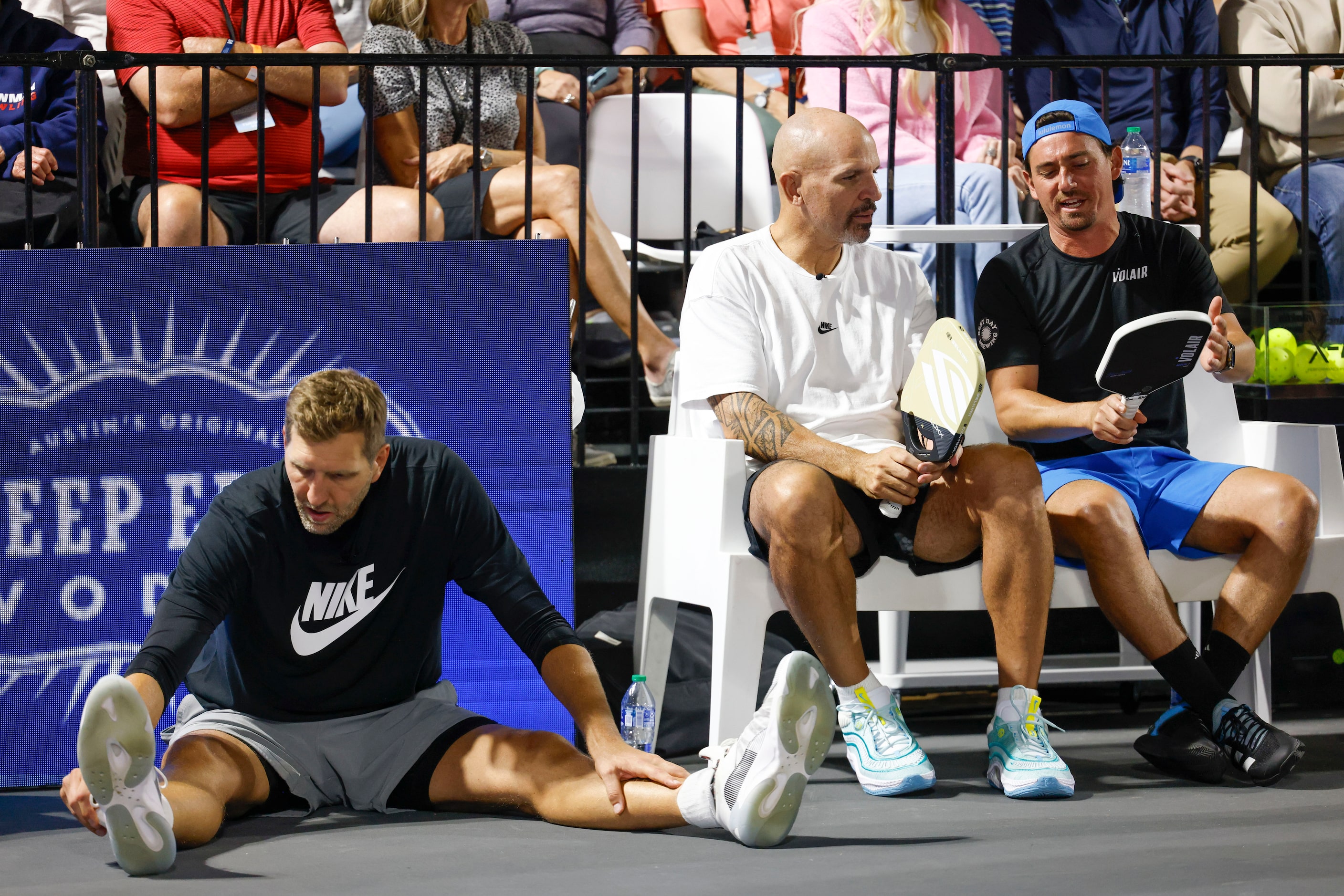 Dallas Mavericks player and basketball hall of famer Dirk Nowitzki (left) stretches as...