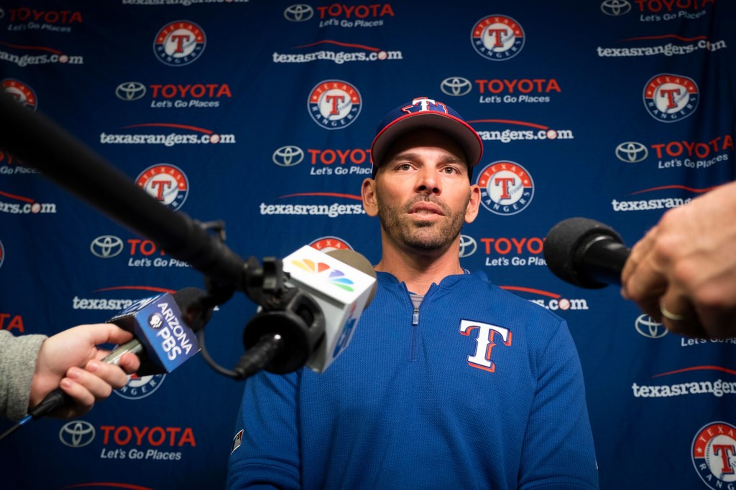 Texas Rangers manager Chris Woodward addresses the media before a spring training workout at...