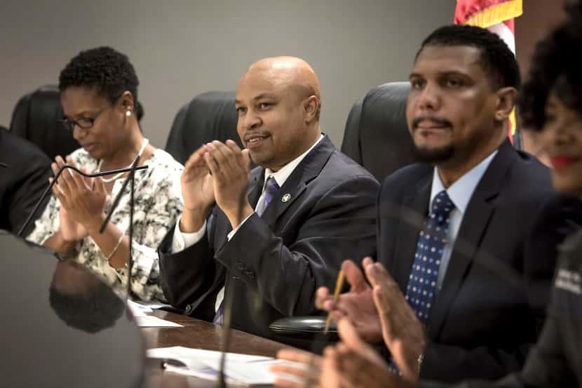 DeSoto Mayor Carl Sherman (center) sits with city secretary Kisha Morris (left) and City...