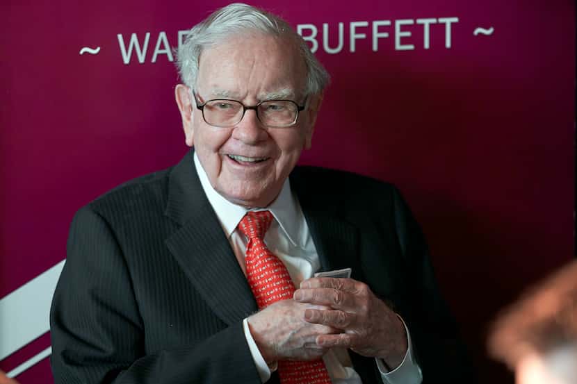 FILE - Warren Buffett, chairman and CEO of Berkshire Hathaway, smiles as he plays bridge...