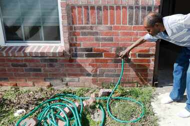 When Raymond Williams turns on his faucet, water runs through the bricks in front of the...