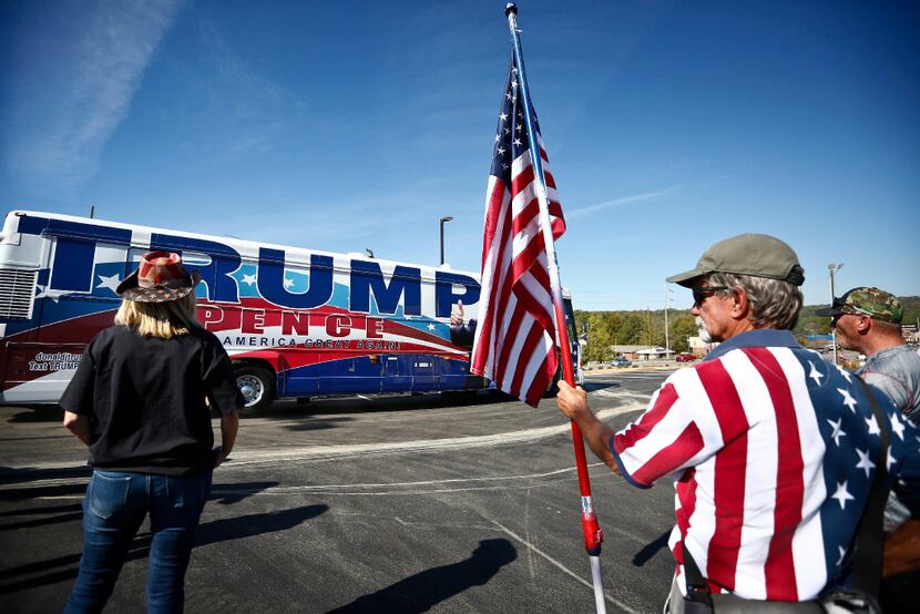Supporters stand near  Donald Trump's bus as it made a campaign stop at Hoover Tactical...