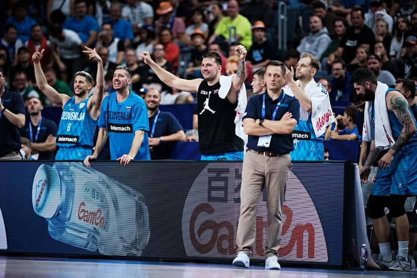 Luka Doncic cheers on his teammates from the bench during Slovenia's runaway win against...