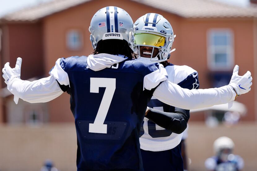 Dallas Cowboys wide receiver CeeDee Lamb (88) and cornerback Trevon Diggs (7) hug it out...