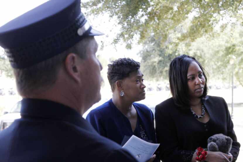 Deanna Williams (right) was escorted into her husband's funeral Friday by Benetha Johnson, a...