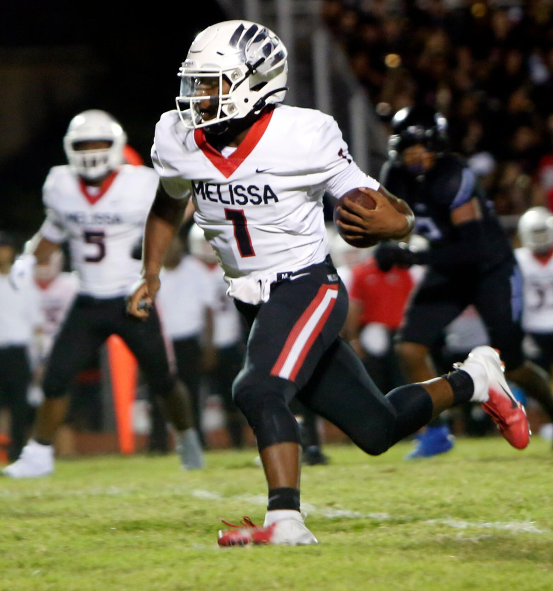 Melissa quarterback Brendon Lewis (1) rambles deep into the Trinity Christian Cedar Hill...