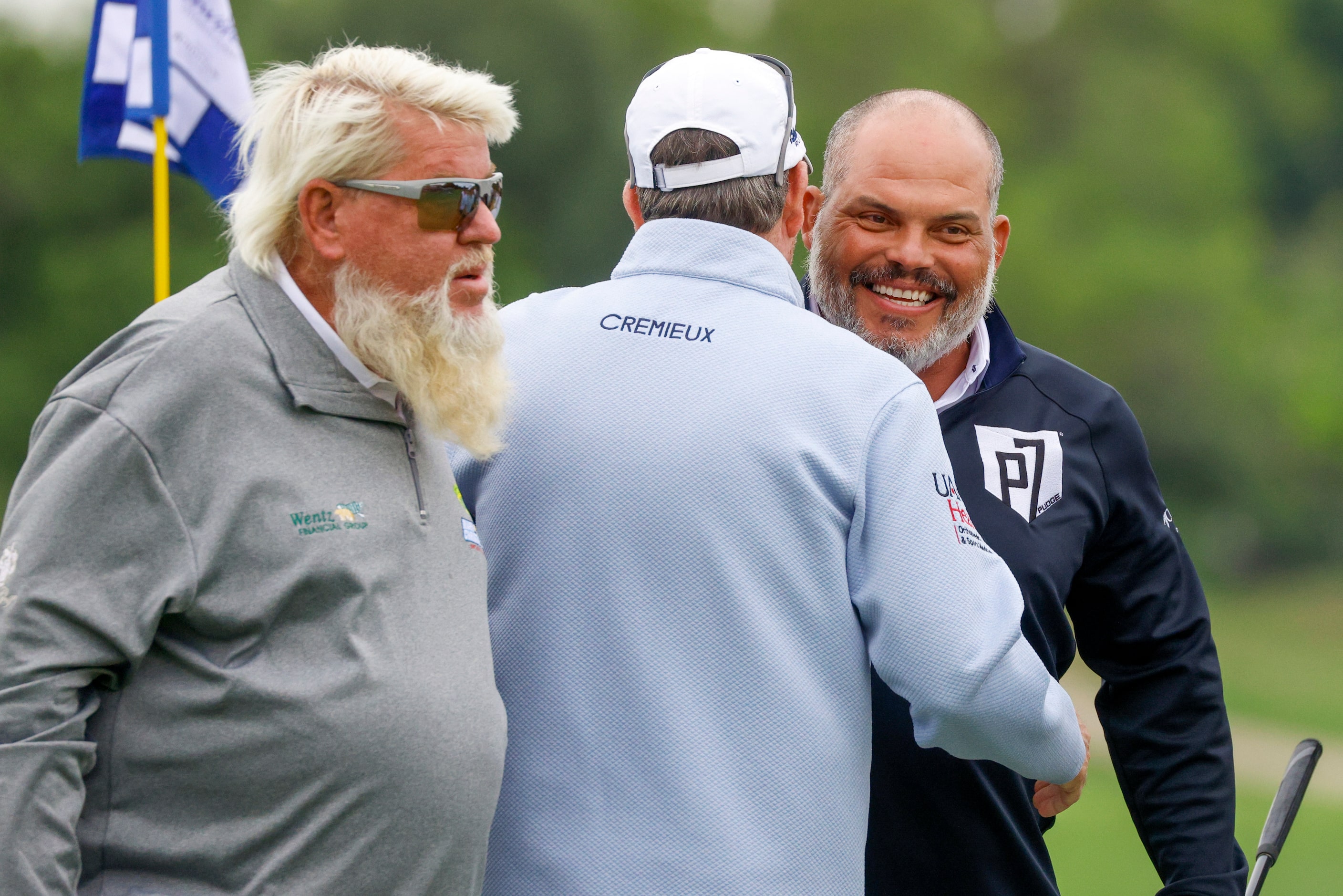 Texas Rangers Hall of Fame catcher Iván “Pudge” Rodríguez hugs professional golfer Glen Day...