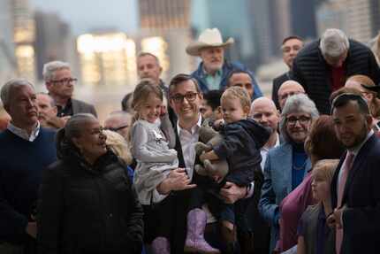 Dallas City Councilman Scott Griggs, middle, holds his children 4-yr-old Catalina Griggs,...