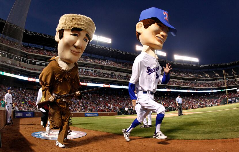 Texas Rangers mascot Nolan Ryan races Davy Crockett during the seventh inning Legends Race,...