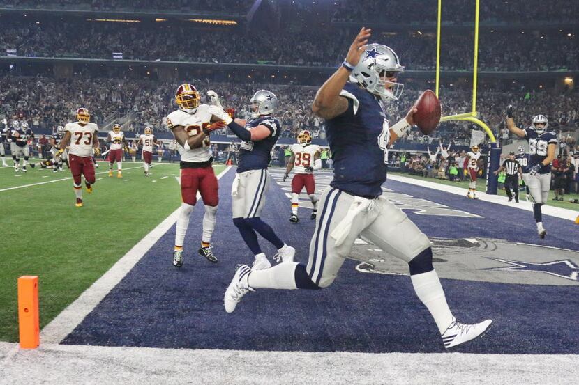 Dallas Cowboys quarterback Dak Prescott (4) scores on a fourth-quarter touchdown run in...