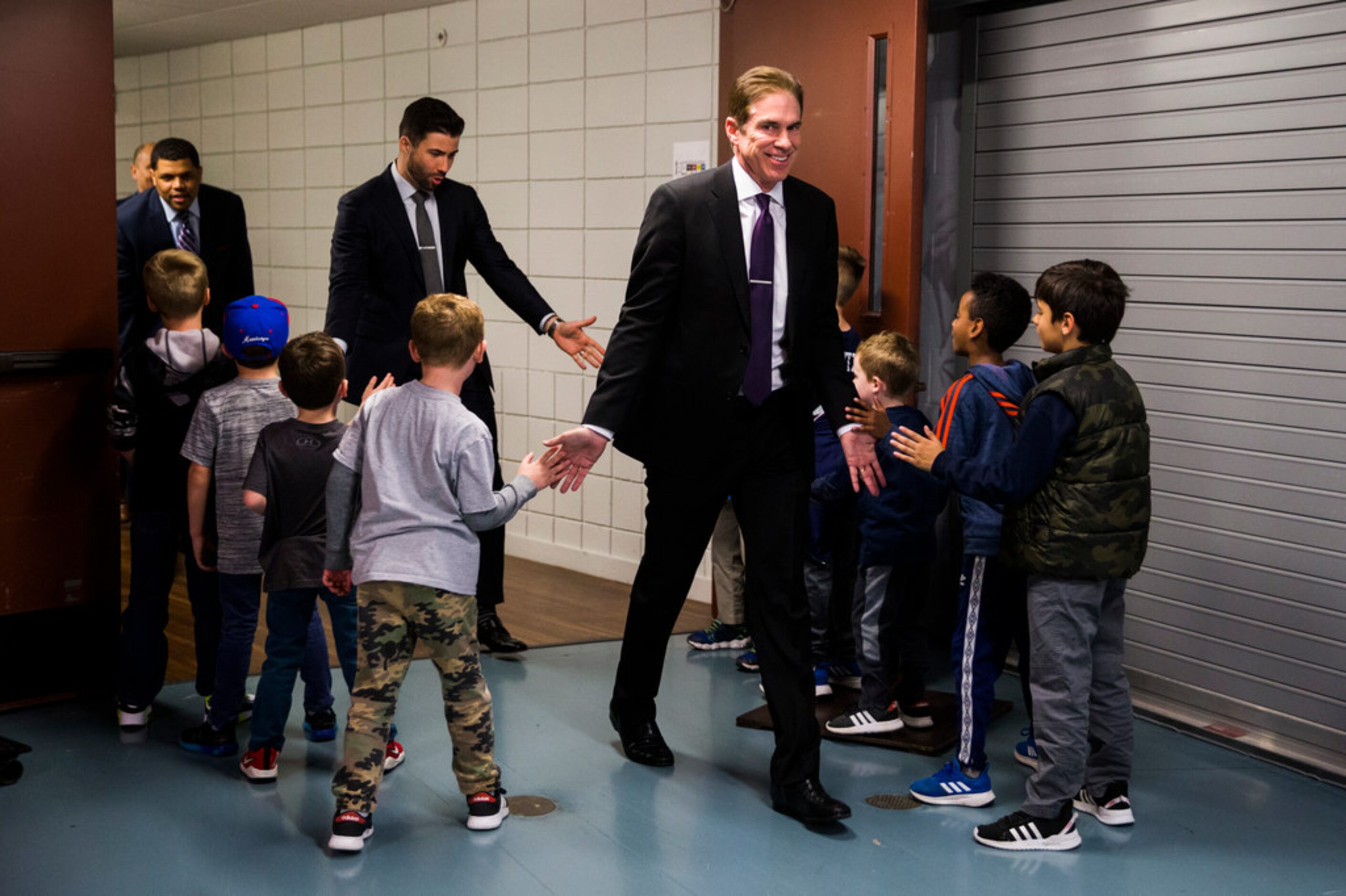 Southern Methodist Mustangs head coach Tim Jankovich and other coaches and staff are greeted...