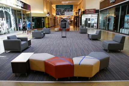 Some seats were marked off as closed to encourage social distancing at Grapevine Mills on...