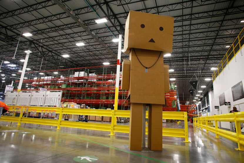 A giant box man stands at the entrance of the Amazon fulfillment center in Coppell. Amazon...