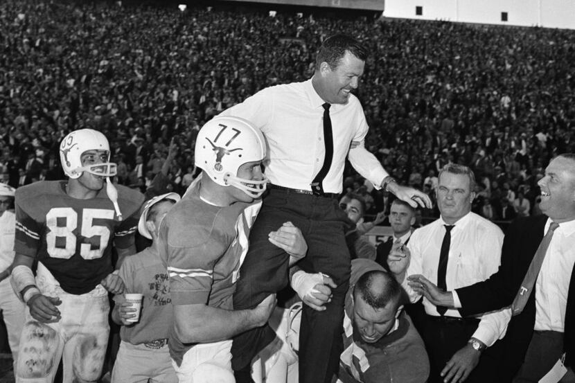 Texas players hoist their coach Darrell Royal to their shoulders after beating Texas A&M...