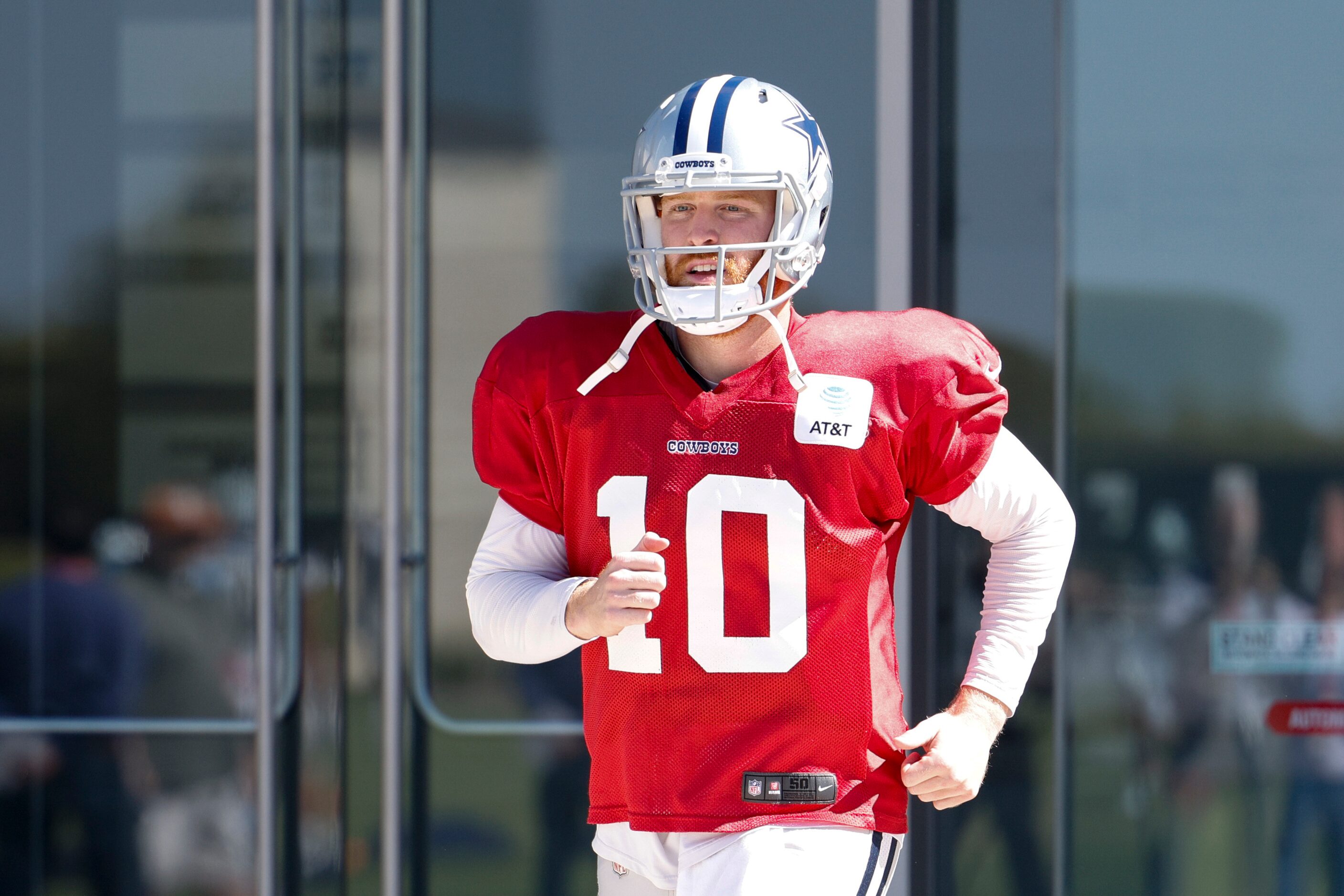 Dallas Cowboys quarterback Cooper Rush (10) jogs to the field during a practice at The Star,...