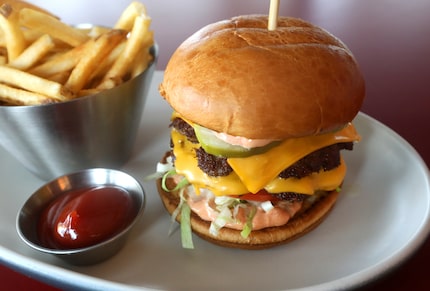 The Local Burger at Local Public Eatery in Dallas is made with two beef patties, two slices...