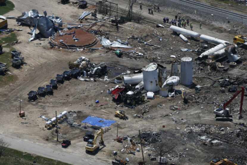 The damage from the fertilizer plant explosion is seen from helicopters in accompanying...