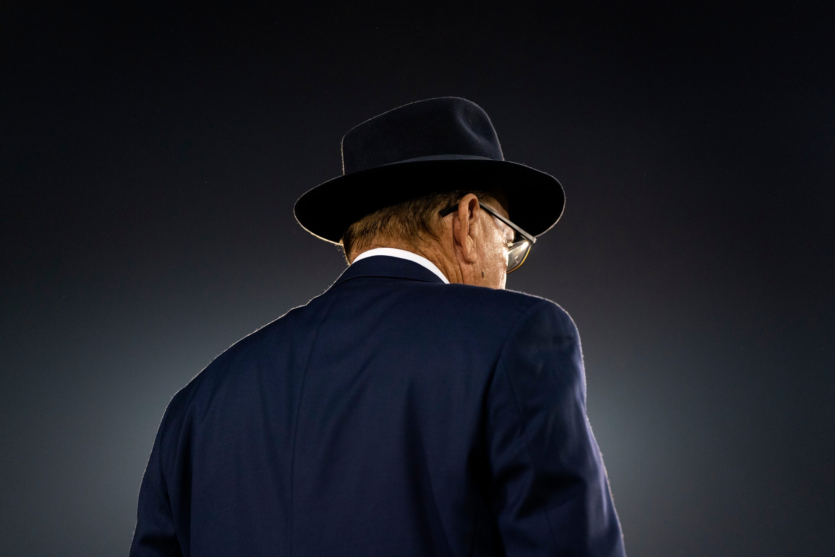 Legendary Highland Park head coach Randy Allen, wearing his trademark fedora, stands on the...