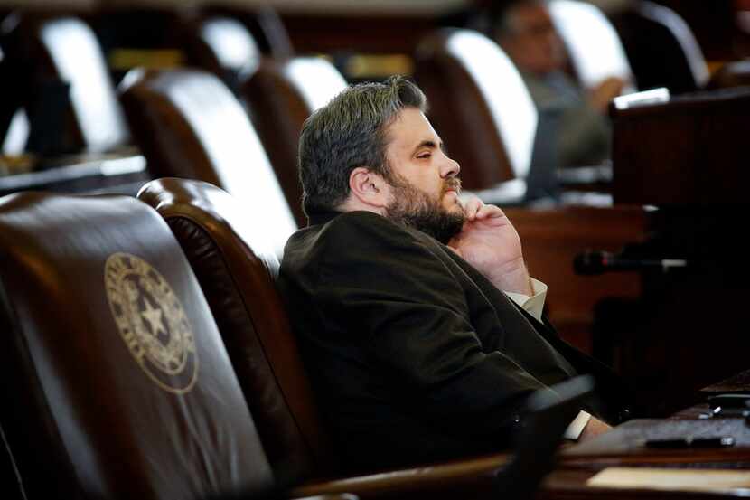 Texas Rep. Jonathan Stickland, R-Bedford, listens to proceedings from his desk during the...