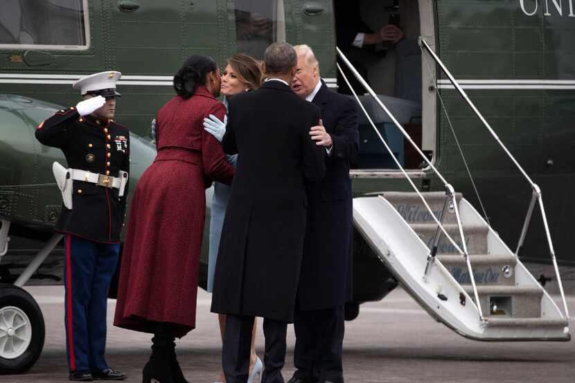 President Donald Trump and first lady Melania Trump escort former President Barack Obama and...