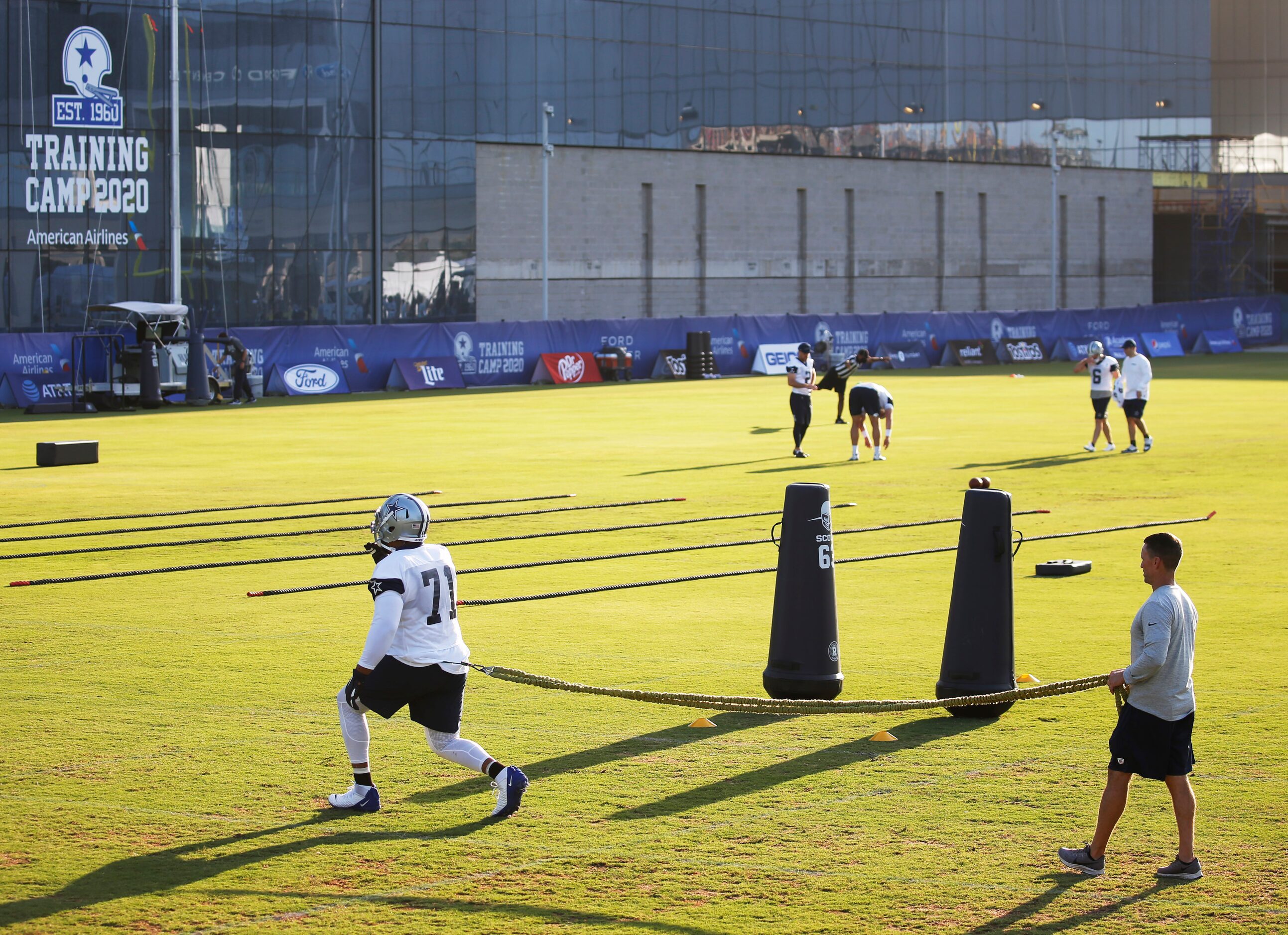 Dallas Cowboys offensive tackle La'el Collins (71) works with Dallas Cowboys trainer Britt...