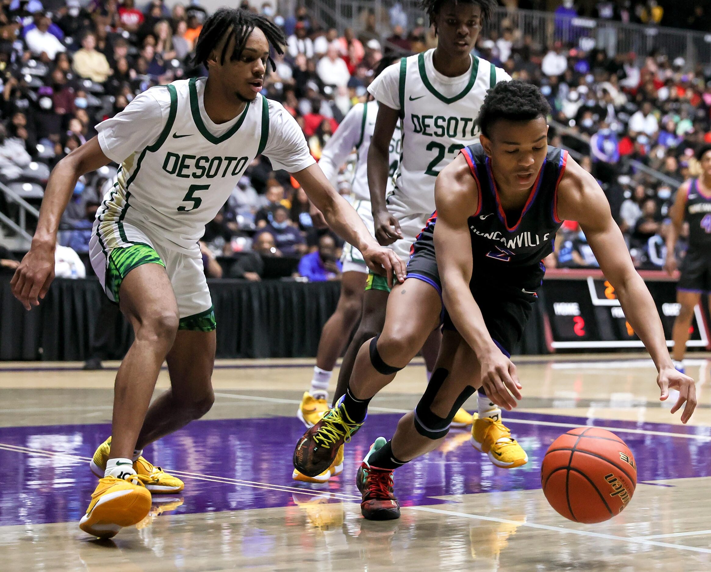 Duncanville guard Evan Phelps (2) tries to go for a loose ball against DeSoto forward Ahmir...