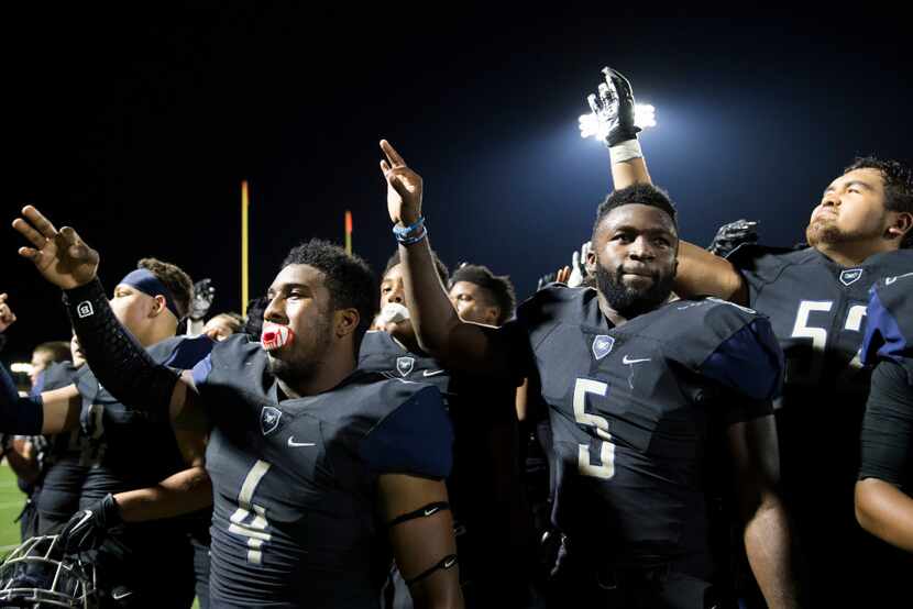 Wylie East's Eno Benjamin (5) and teammate Corey Gentle (4) celebrate after a varsity...
