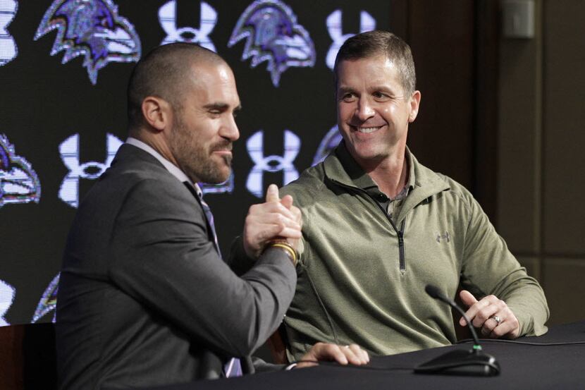 Baltimore Ravens head coach John Harbaugh, right, embraces newly-signed safety Eric Weddle...