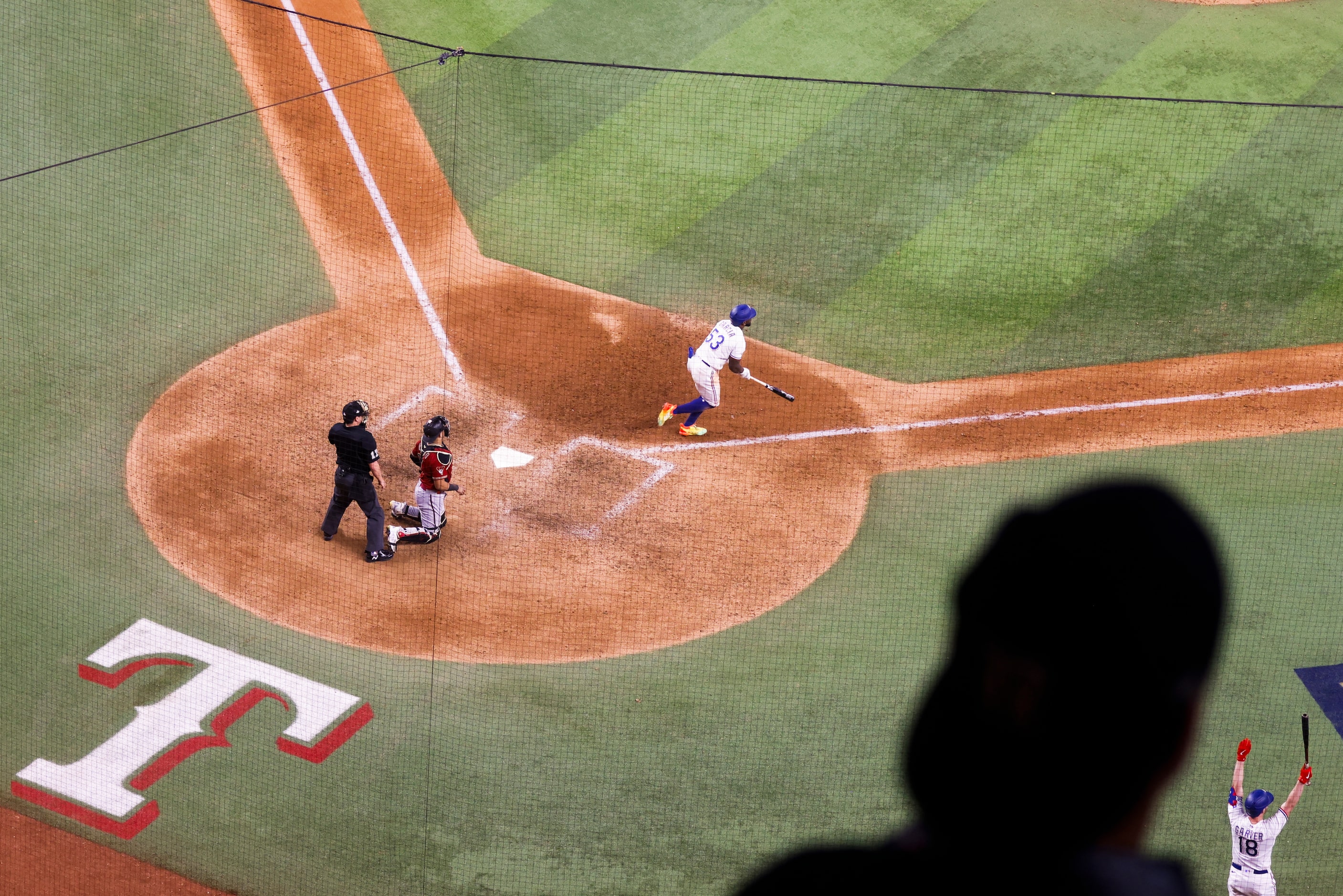 Texas Rangers Adolis Garcia watches the flight of his game-winning walk-off home run to...