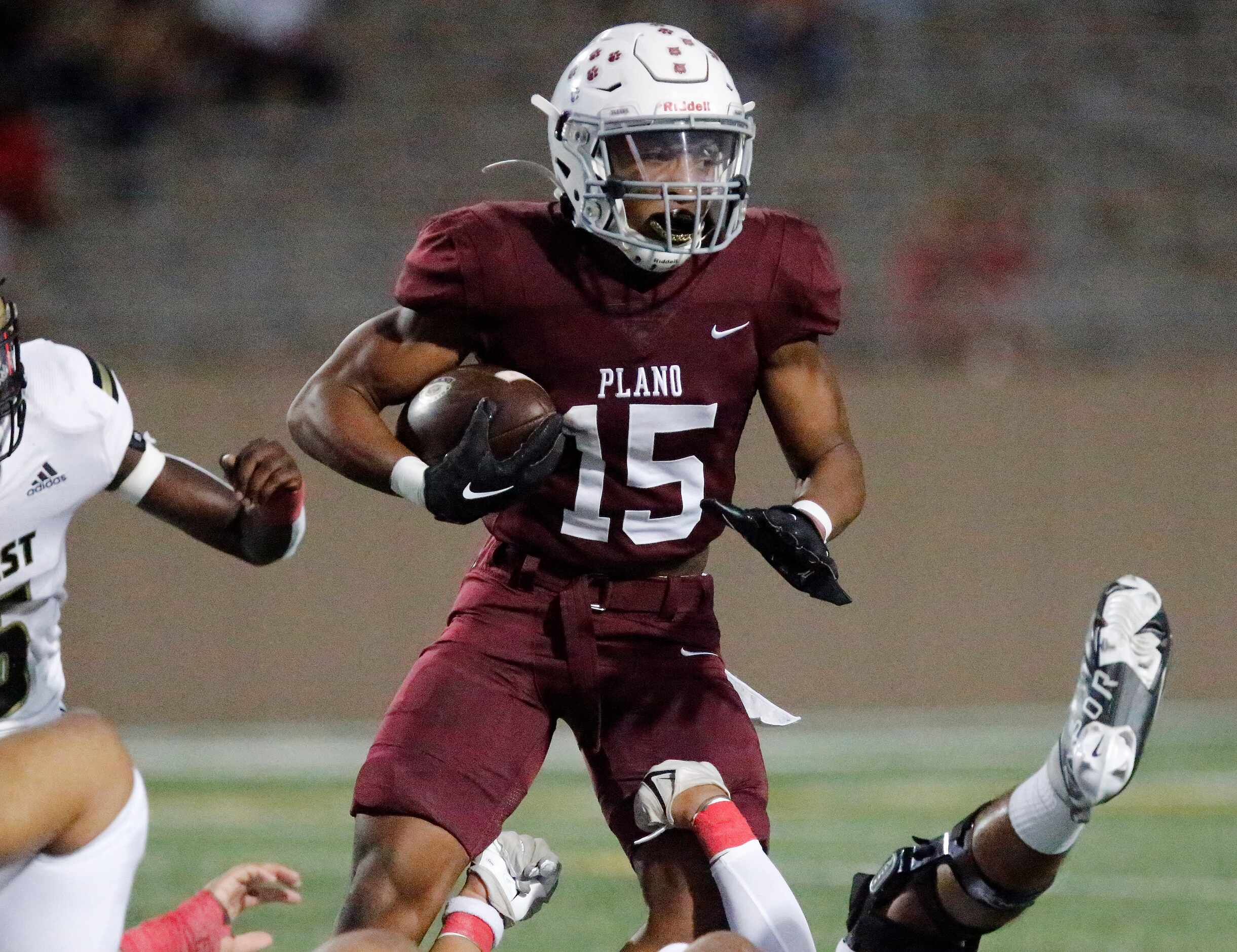 Plano Senior High School running back Joshua Campbell (15) looks for room to run during the...