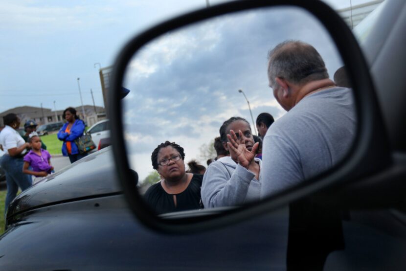 Activist and organizer Luis Sepulveda (right, in mirror), tries to get people signed up as...