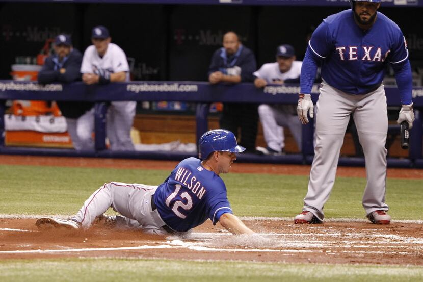 Apr 5, 2014; St. Petersburg, FL, USA; Texas Rangers shortstop Josh Wilson (12) slides safely...