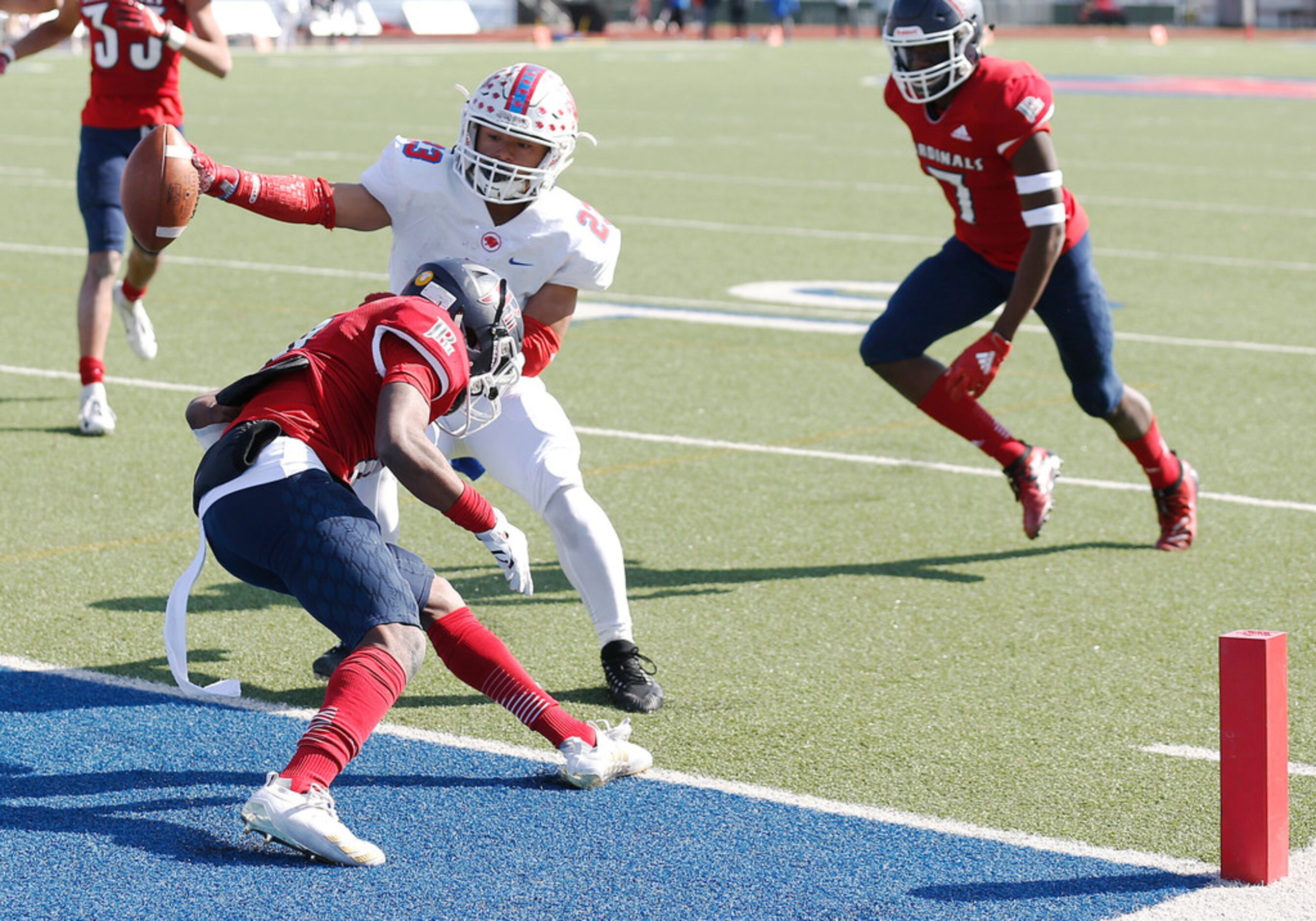 Parish Episcopal's Christian Benson (23) scores a touchdown in front of Plano John Paul II's...