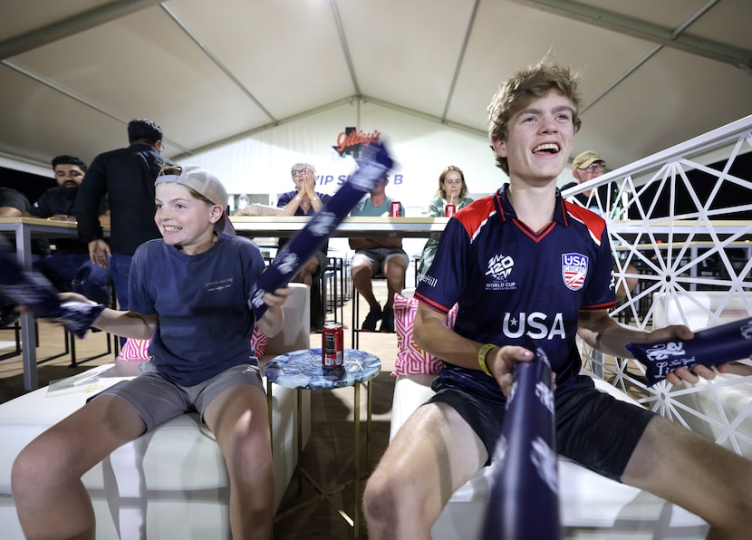 13-year-old Matthew Keller (left) and 15-year-old Brendan Keller yell and cheer during the...