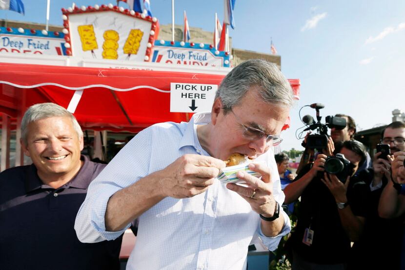 Republican presidential candidate, former Florida Gov. Jeb Bush, eats a deep fried candy bar...