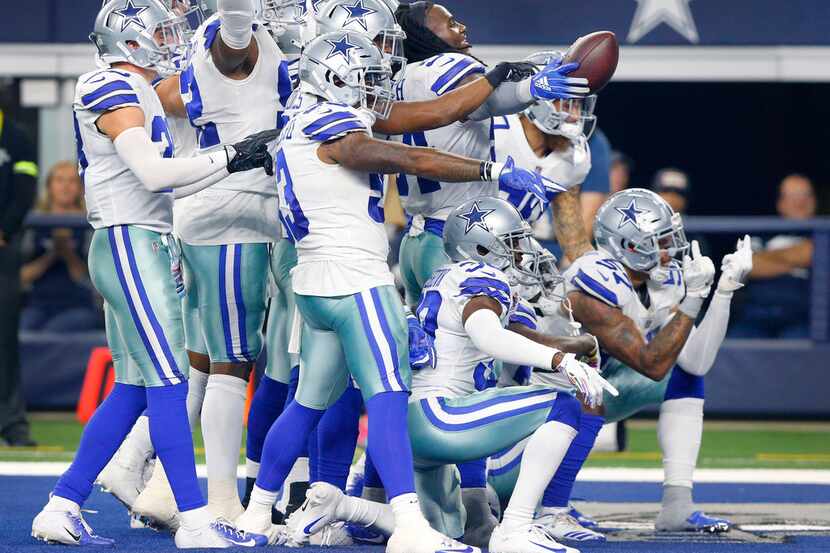 The Dallas Cowboys defense poses for a photo in the end zone after Dallas Cowboys linebacker...