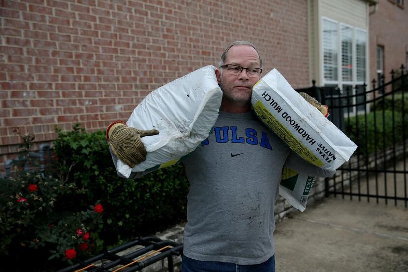 
HOA member Keith Kerwin moves mulch.
