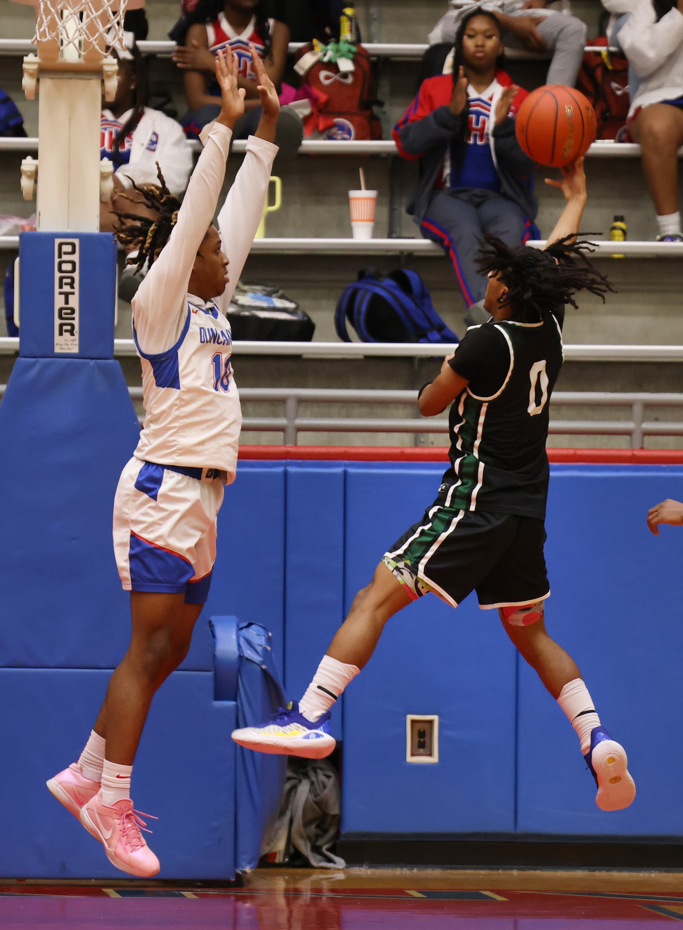 DeSoto guard Miles Pitt (0) gets off a shot as Duncanville's Gary Jones (10) defends during...