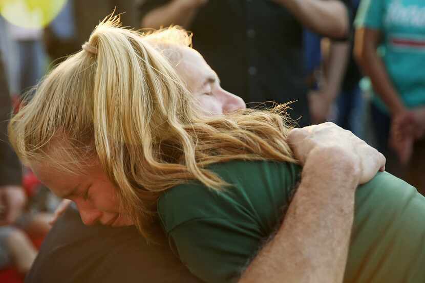 Gov. Greg Abbott hugs Santa Fe High School student Rylie Bouvier, 15, during a vigil along...