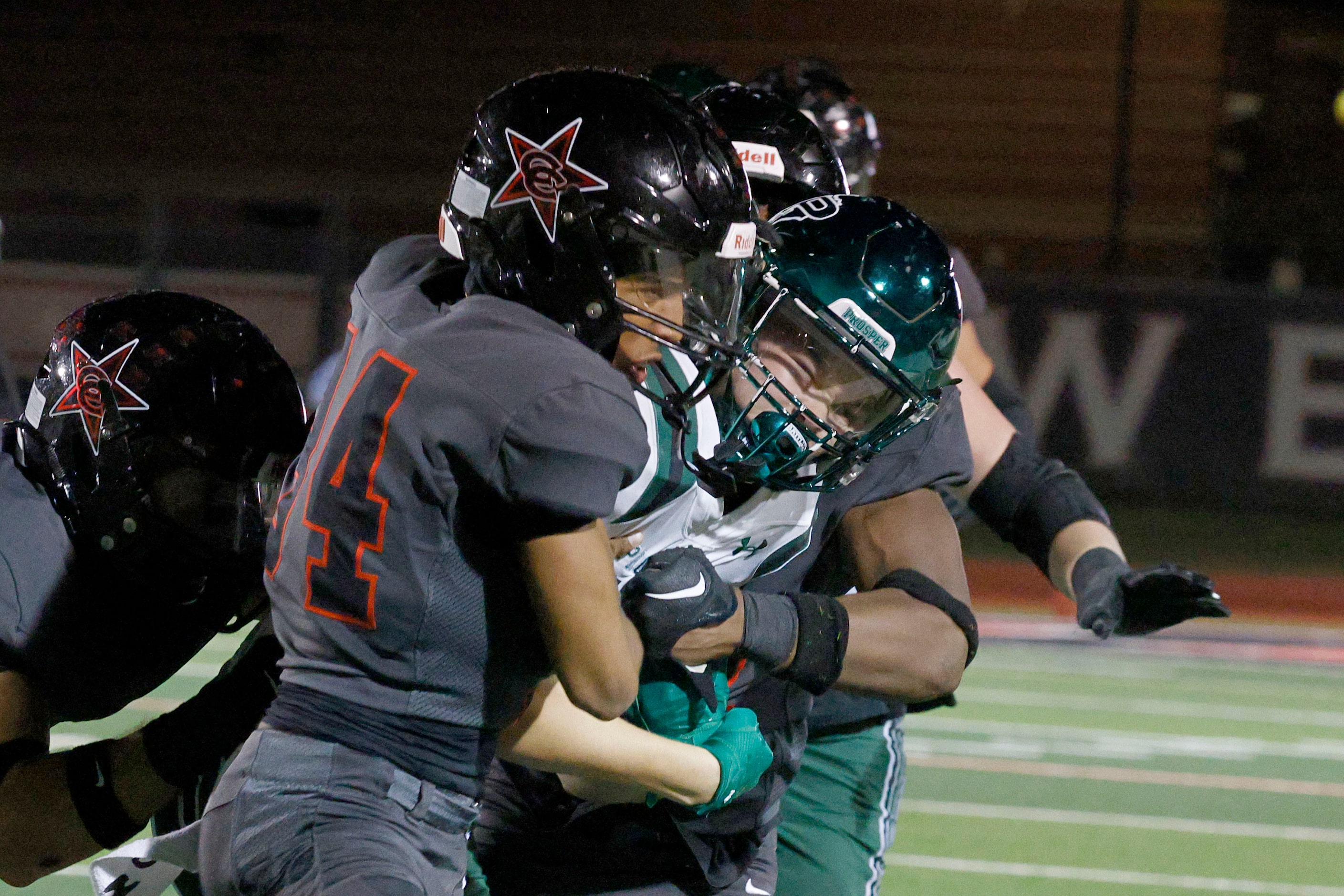 Prosper's Elliot Brown (12) is tackled by Coppell's Tyrell Roberson (34) in the second half...