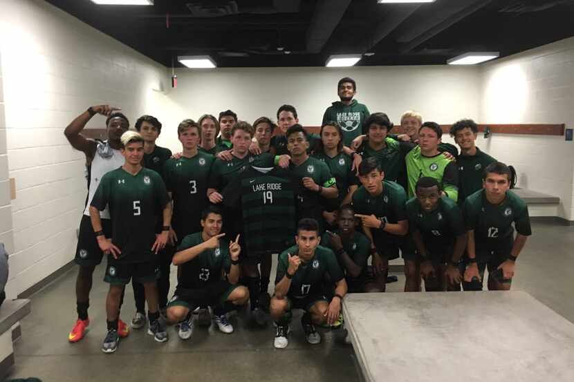 The Mansfield Lake Ridge soccer team holding Alejandro Perez's No. 19 jersey following their...