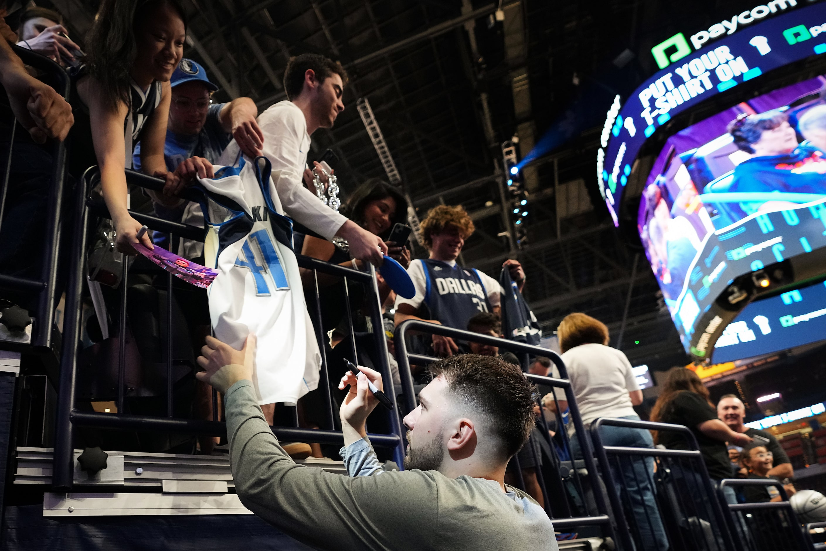 Dallas Mavericks guard Luka Doncic signs autographs before Game 5 of an NBA basketball...