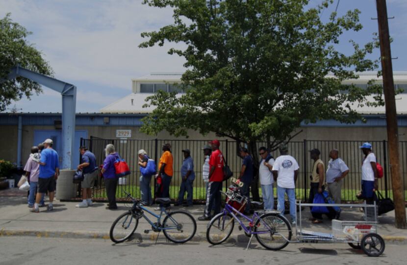 Men lined up Tuesday afternoon outside the Austin Street Shelter, where services are...