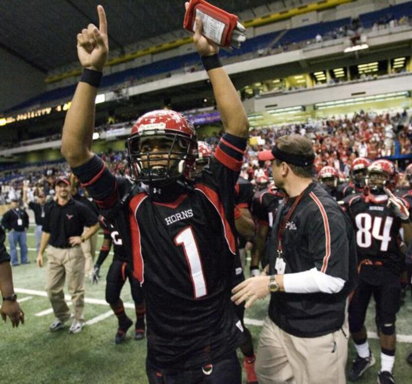 
Cedar Hill quarterback Will Cole cheers after the Longhorns won the 2006 Class 5A Division...