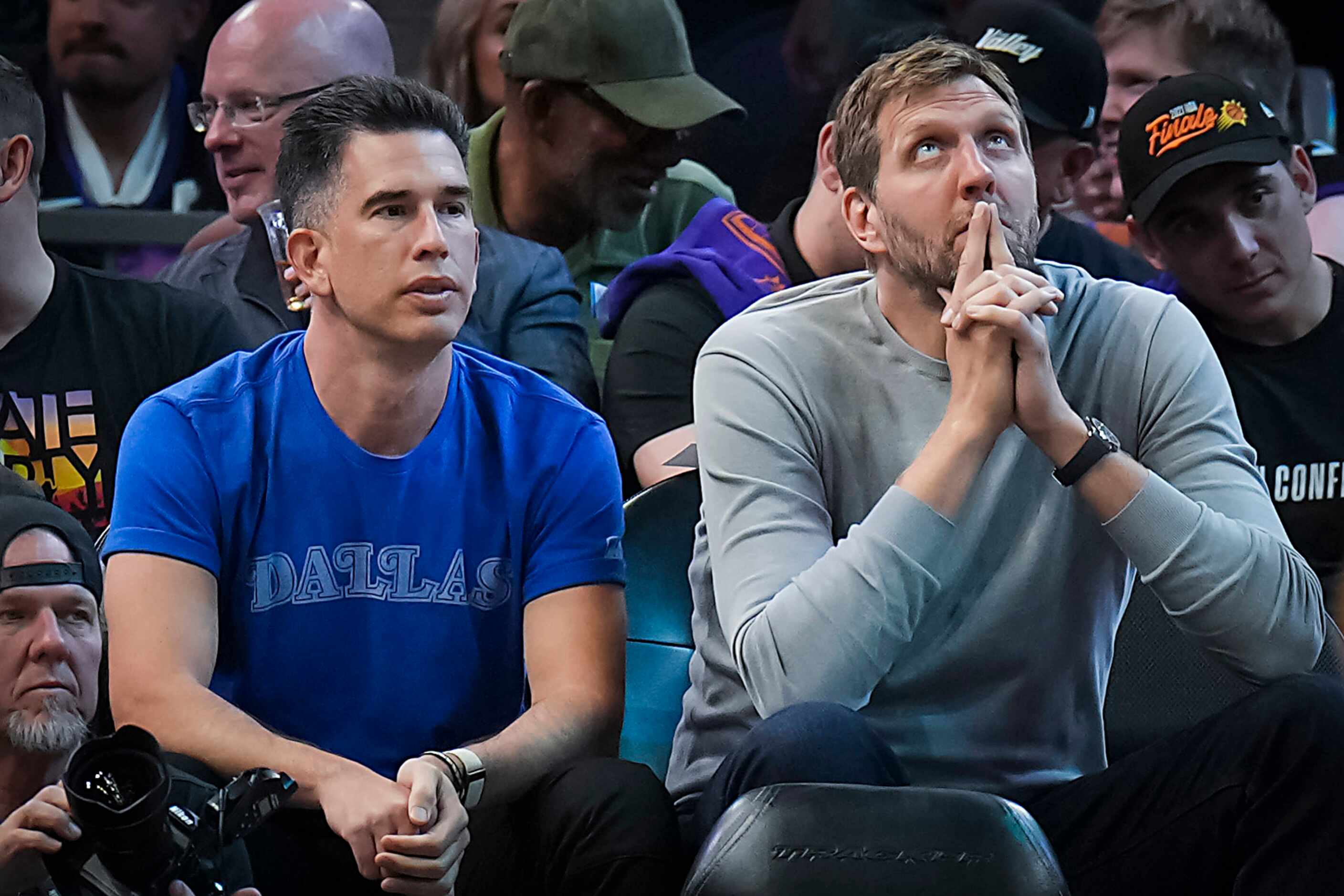 Former Dallas Mavericks player Dirk Nowitzki (right) watches from courtside during the...
