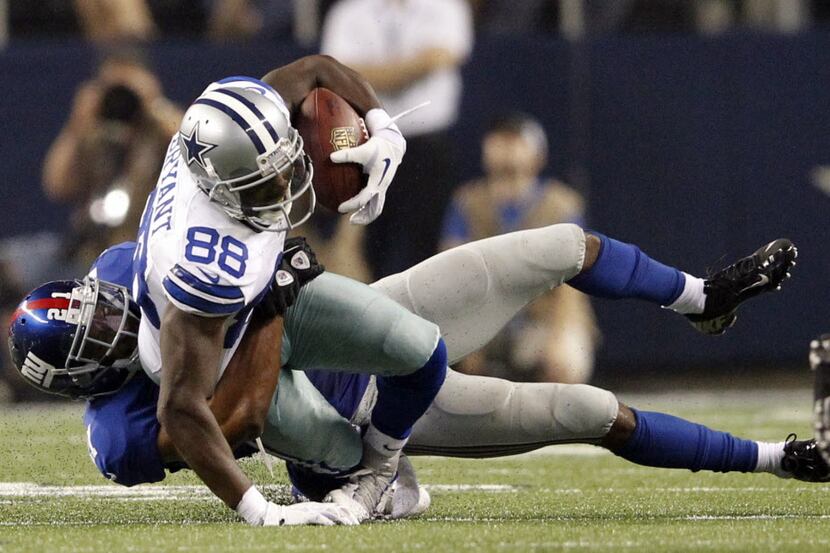 Dallas Cowboys wide receiver Dez Bryant (88) gets his ankle twisted as New York Giants free...