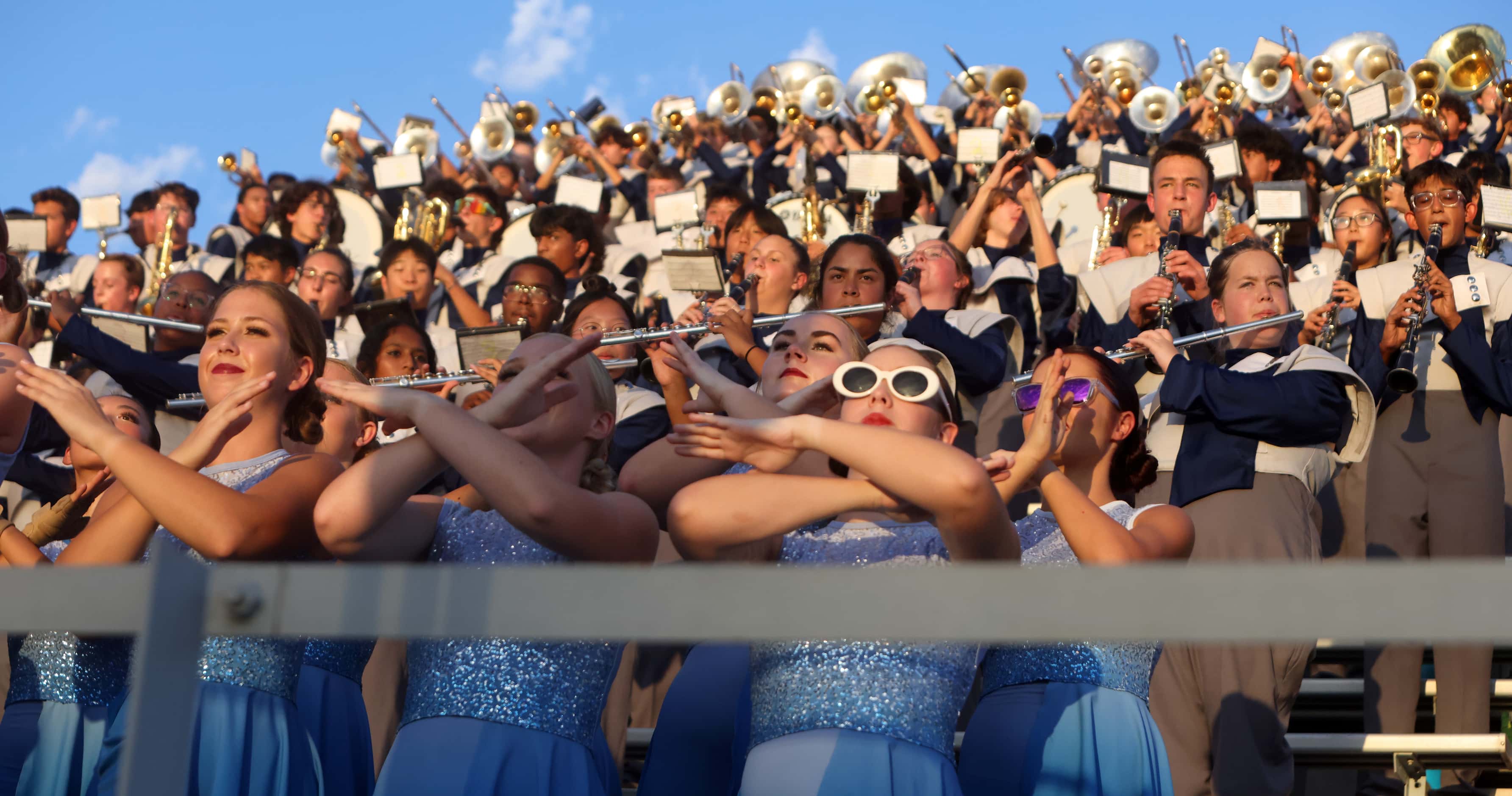 Members of the Flower Mound band and flag corps perform in the stands just prior to the...