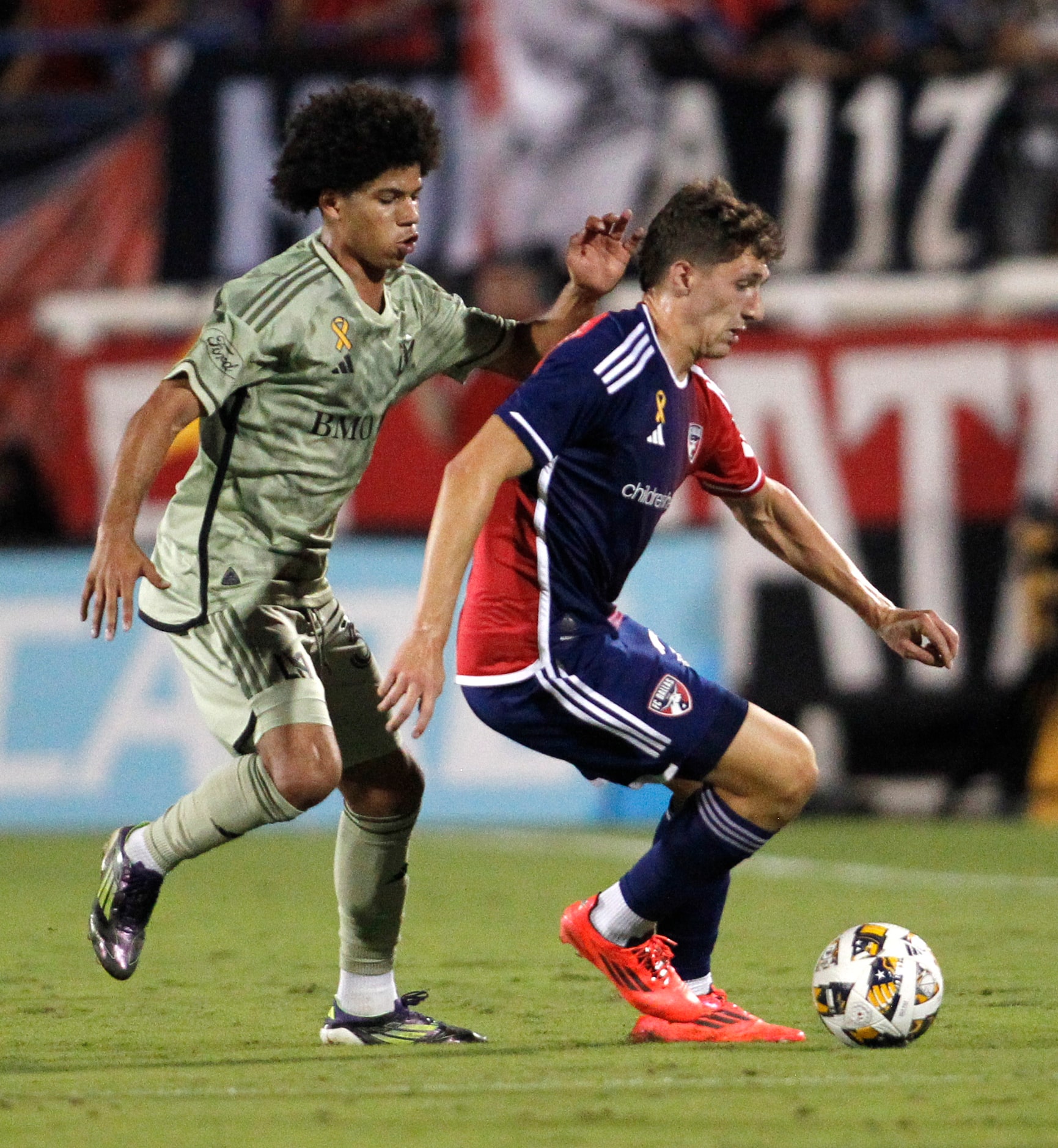 FC Dallas attacker Logan Farrington (23), right, controls the ball as LAFC attacker David...