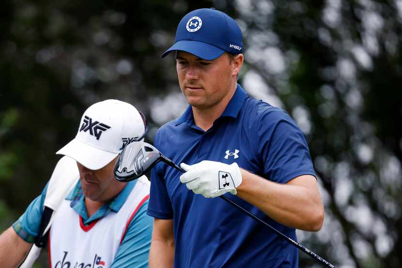Professional golfer Jordan Spieth looks at his club face after hitting his drive off the No....