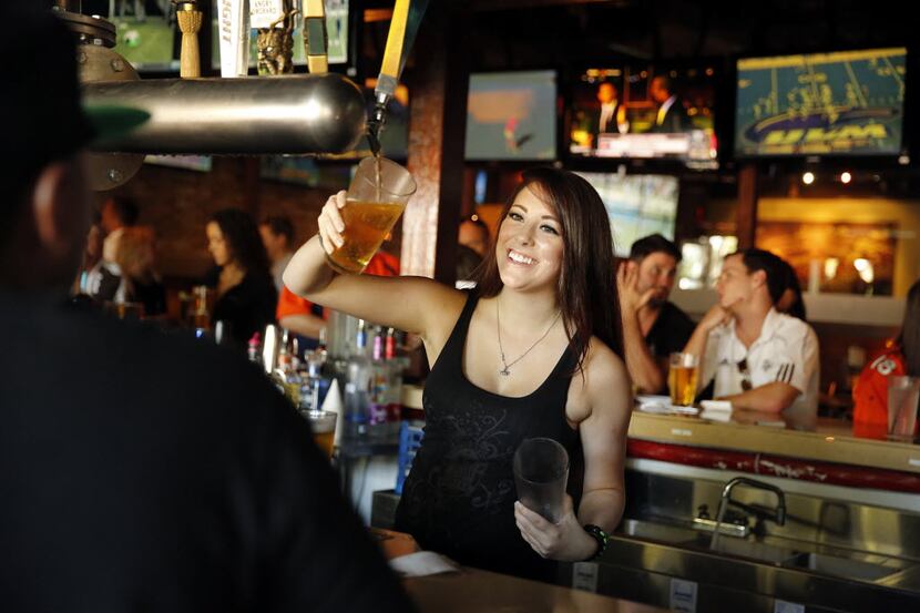 Boomerjack's Grill and Bar server Keigan Smith visits with patrons at their North Arlington,...